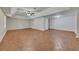This basement has light-brown flooring, a fan, and access to other parts of the house at 3792 Refinement Way, Douglasville, GA 30135