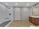 This bathroom offers a large tiled shower and stylish vanity with a wooden-trim mirror at 3792 Refinement Way, Douglasville, GA 30135