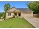 Charming home features a manicured lawn and a two-car garage at 3792 Refinement Way, Douglasville, GA 30135