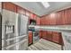 Beautiful kitchen with stainless steel appliances, wood cabinets, and plank flooring at 3792 Refinement Way, Douglasville, GA 30135
