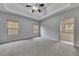 Spacious main bedroom with tray ceiling and adjoining bathroom at 3792 Refinement Way, Douglasville, GA 30135