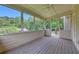 Relaxing sunroom with a ceiling fan and large windows offering beautiful wooded views at 3792 Refinement Way, Douglasville, GA 30135