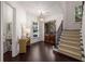 Inviting foyer with hardwood floors, a staircase, and elegant decor, creating a warm and welcoming entrance at 625 Society St, Alpharetta, GA 30022