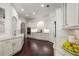 Bright kitchen features custom white cabinets, granite countertops, stainless steel appliances, and hardwood flooring at 625 Society St, Alpharetta, GA 30022