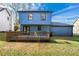 Rear exterior view of two-story home, featuring a spacious backyard and wooden deck at 801 Arbor Hill Dr, Stone Mountain, GA 30088