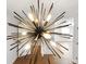 Unique starburst chandelier hanging in dining room with hardwood flooring at 801 Arbor Hill Dr, Stone Mountain, GA 30088