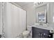 Bathroom featuring a white shower curtain, dark vanity, and well-lit mirror at 1094 Township Sq, Alpharetta, GA 30022