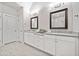 Bathroom with double vanity, framed mirrors, and tile floors at 1094 Township Sq, Alpharetta, GA 30022