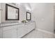 Bathroom with double vanity, framed mirrors, and tile floors at 1094 Township Sq, Alpharetta, GA 30022