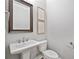 Clean bathroom featuring white fixtures, pedestal sink and framed mirror at 1094 Township Sq, Alpharetta, GA 30022