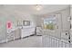 Bedroom featuring floral wallpaper, white crib, and plenty of natural light at 1094 Township Sq, Alpharetta, GA 30022