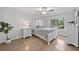 Cozy bedroom with hardwood floors, neutral decor, a ceiling fan, and bright natural light at 1094 Township Sq, Alpharetta, GA 30022