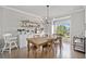 Bright dining area featuring hardwood floors, modern lighting, and ample natural light at 1094 Township Sq, Alpharetta, GA 30022