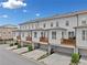 Row of townhomes with decks, garages, and meticulously kept lawns on a sunny day at 1094 Township Sq, Alpharetta, GA 30022