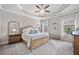 Bedroom featuring tray ceiling, fan, and natural light at 1094 Township Sq, Alpharetta, GA 30022