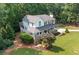 Aerial view of a two-story home featuring a covered front porch, complemented by mature trees and landscaped grounds at 226 Nacoochee Dr, Woodstock, GA 30188