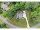 Aerial view of a home with mature landscaping, a driveway, and a backyard at 226 Nacoochee Dr, Woodstock, GA 30188