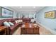 The basement living area features a leather sectional sofa, rug, and tile floors at 226 Nacoochee Dr, Woodstock, GA 30188
