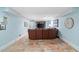 This basement living room has tile floors, light blue walls, and a leather sofa at 226 Nacoochee Dr, Woodstock, GA 30188