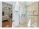 Bathroom featuring a glass shower, doorway to the bedroom and natural light at 226 Nacoochee Dr, Woodstock, GA 30188