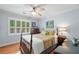 This bedroom features plantation shutters, hardwood floors, and a ceiling fan at 226 Nacoochee Dr, Woodstock, GA 30188
