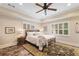This bedroom features a ceiling fan, window with shutters, and decorative rug at 226 Nacoochee Dr, Woodstock, GA 30188