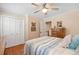 This bedroom features a ceiling fan, hardwood floors, closet, and cream painted walls at 226 Nacoochee Dr, Woodstock, GA 30188