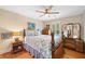 The bedroom features hardwood floors, a ceiling fan, window, and a large dresser with mirror at 226 Nacoochee Dr, Woodstock, GA 30188