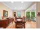 Elegant dining room with wood table, stained glass and large windows with natural light and hardwood flooring at 226 Nacoochee Dr, Woodstock, GA 30188