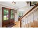 Bright entryway features a stained glass window, hardwood floors, and a staircase with white spindles at 226 Nacoochee Dr, Woodstock, GA 30188