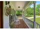 Inviting covered front porch with wooden floors features rocking chairs and charming decor at 226 Nacoochee Dr, Woodstock, GA 30188