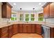 Modern kitchen with granite countertops, stainless steel appliances, and a view of the serene outdoors at 226 Nacoochee Dr, Woodstock, GA 30188