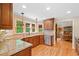 Well-equipped kitchen with granite countertops and stainless appliances offers ample space for cooking and entertaining at 226 Nacoochee Dr, Woodstock, GA 30188