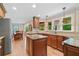 Open kitchen with stainless appliances, granite counters, and hardwood floors overlooks the dining area at 226 Nacoochee Dr, Woodstock, GA 30188