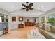 Bright and spacious living room boasts hardwood floors, vaulted ceilings, and seamless flow to dining area at 226 Nacoochee Dr, Woodstock, GA 30188