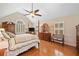 Bright main bedroom featuring vaulted ceilings, four-poster bed and hardwood floors at 226 Nacoochee Dr, Woodstock, GA 30188