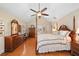 Bright main bedroom showcasing vaulted ceilings, a four-poster bed and hardwood floors at 226 Nacoochee Dr, Woodstock, GA 30188