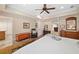 Spacious main bedroom features a ceiling fan, sitting area, and access to an ensuite bathroom at 226 Nacoochee Dr, Woodstock, GA 30188