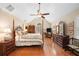 Spacious main bedroom with vaulted ceilings, four-poster bed and hardwood floors at 226 Nacoochee Dr, Woodstock, GA 30188