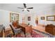 Spacious home office with hardwood floors, a desk, and a patterned chair, featuring a large mirror at 226 Nacoochee Dr, Woodstock, GA 30188
