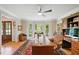 Well-lit home office featuring a bay window, a desk, and a patterned chair with hardwood floors at 226 Nacoochee Dr, Woodstock, GA 30188