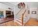 Traditional staircase with hardwood steps, white risers and wooden railing, leading to the upper level at 226 Nacoochee Dr, Woodstock, GA 30188