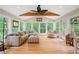 Bright sunroom with large windows, vaulted ceiling, a ceiling fan, and comfortable seating at 226 Nacoochee Dr, Woodstock, GA 30188