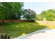 A spacious backyard that features a blooming tree and a privacy fence at 306 Burdock Trce, Woodstock, GA 30188