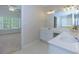 Bathroom with dual sinks and a large mirror at 306 Burdock Trce, Woodstock, GA 30188