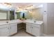 Bathroom with dual vanities, large mirror, and decorative lighting at 306 Burdock Trce, Woodstock, GA 30188