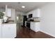 Galley kitchen featuring white cabinets, stainless steel appliances, and granite countertops at 306 Burdock Trce, Woodstock, GA 30188