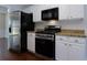 Modern kitchen with stainless steel appliances, granite countertops, and white cabinets at 306 Burdock Trce, Woodstock, GA 30188