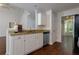 Bright kitchen with granite countertops and stainless steel appliances at 306 Burdock Trce, Woodstock, GA 30188