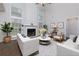 Bright living room with a fireplace, high ceilings, and hardwood floors at 306 Burdock Trce, Woodstock, GA 30188